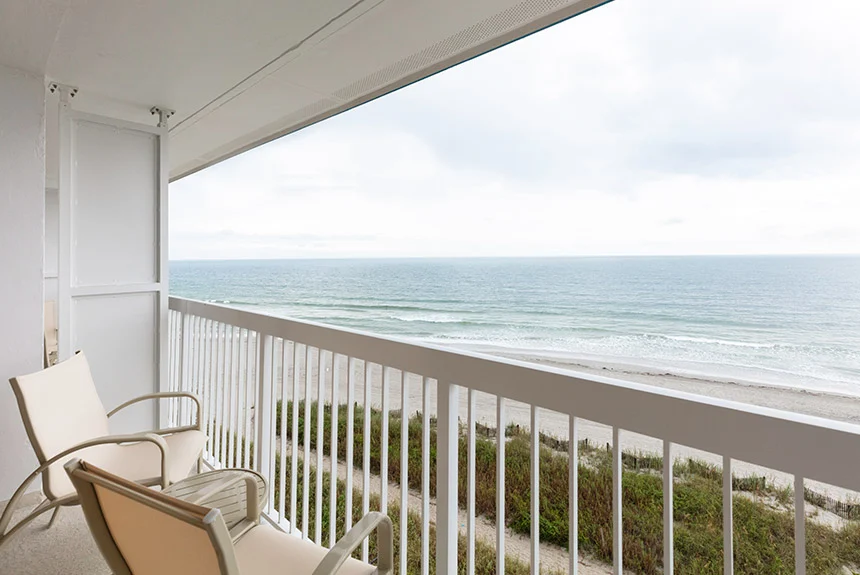 Balcony with two chairs overlooking the beach and ocean from a Westgate Myrtle Beach Oceanfront double oceanfront room