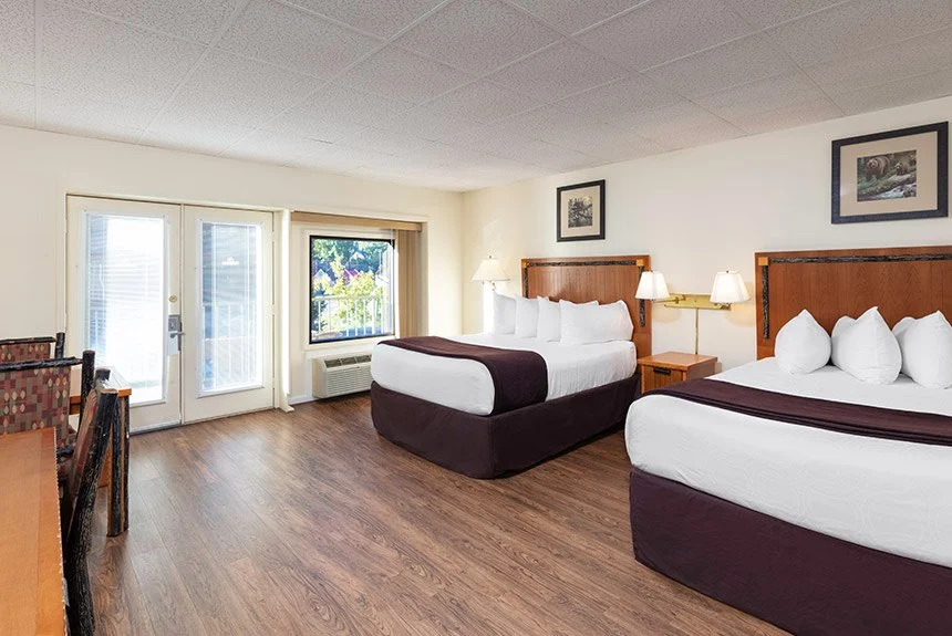 River Terrace Resort hotel room with two beds, burgundy bedding, wood floors and French doors