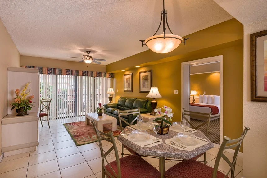 Dining table and living room of a Westgate Towers Resort one-bedroom villa with a view into the bedroom
