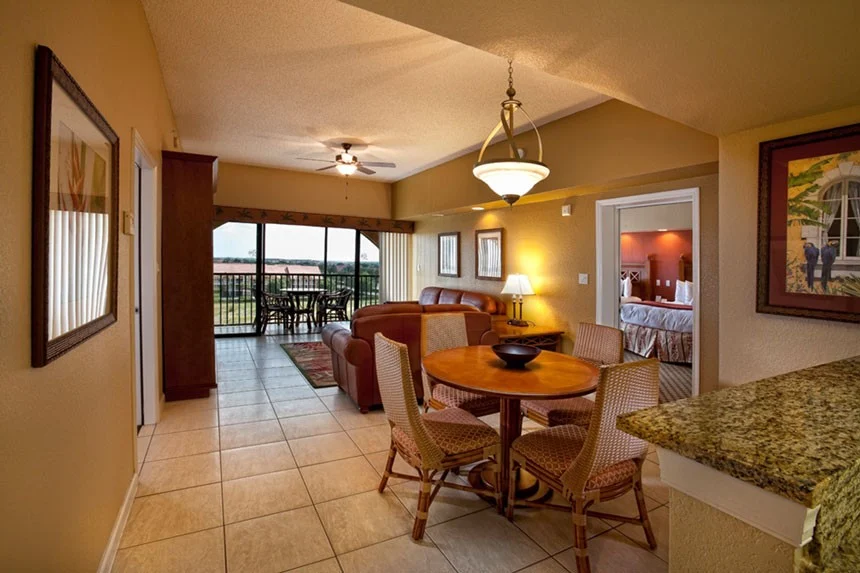 Round dining table, living room and balcony doors in a Westgate Towers Resort two-bedroom villa