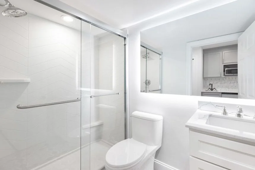 Bathroom of a Westgate Historic Williamsburg Resort studio villa with a glass shower, toilet and white vanity