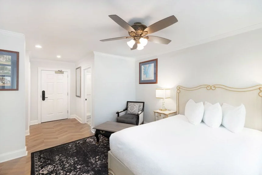 Westgate Historic Williamsburg Resort studio villa with a bed, armchair, ceiling fan and entry door