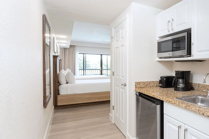 Kitchenette with white cabinets, microwave, coffee maker and mini fridge in a Westgate Towers Resort studio villa