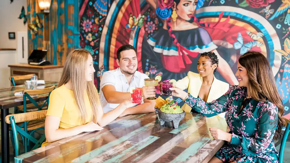 A spread of food and drinks at a poolside bar