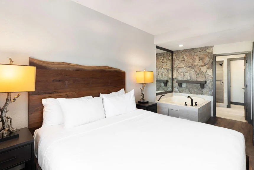 Bedroom of a Westgate Park City Resort & Spa one-bedroom grand villa with a live-edge headboard and jetted tub