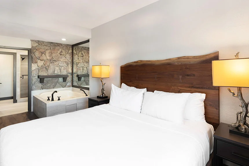 Bedroom of a Westgate Park City Resort & Spa two-bedroom villa with a live-edge headboard and jetted tub