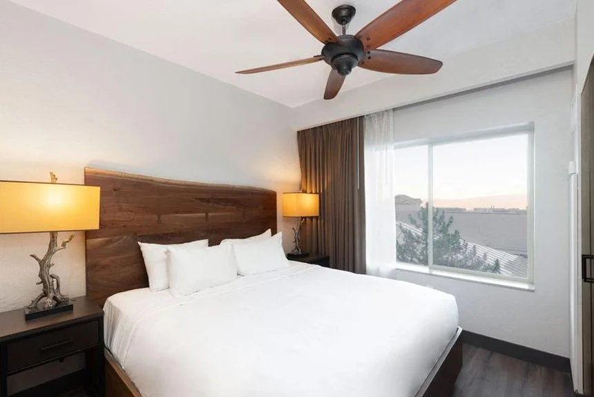 Westgate Park City Resort & Spa studio villa with a bed, live-edge wood headboard, ceiling fan and window view