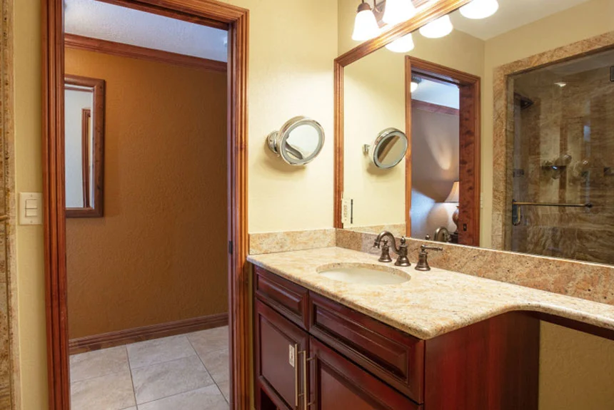 Bathroom of a Westgate Park City Resort & Spa luxury studio with a granite vanity and stone-tiled glass shower