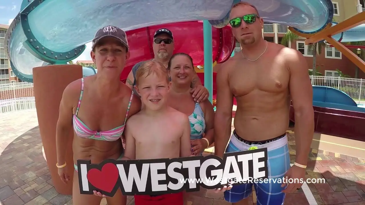 Family posing with an I Love Westgate sign at a resort water playground