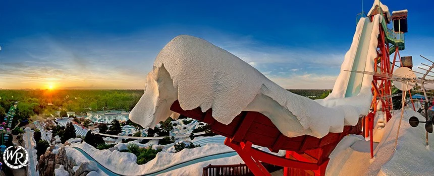 Snow-capped slide tower at Disney's Blizzard Beach at sunset