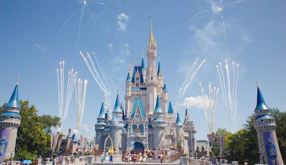 Fireworks bursting in the daytime sky above Cinderella Castle at Magic Kingdom