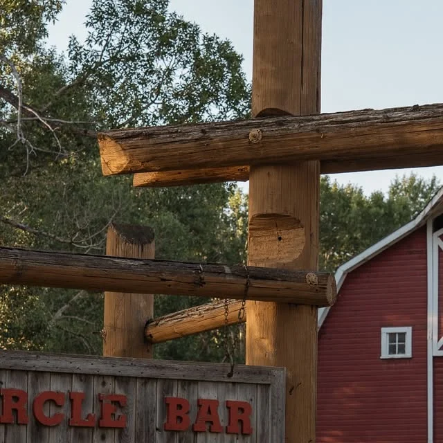 Circle Bar Guest Ranch on Instagram: log gate with a "Circle Bar" sign before a red barn