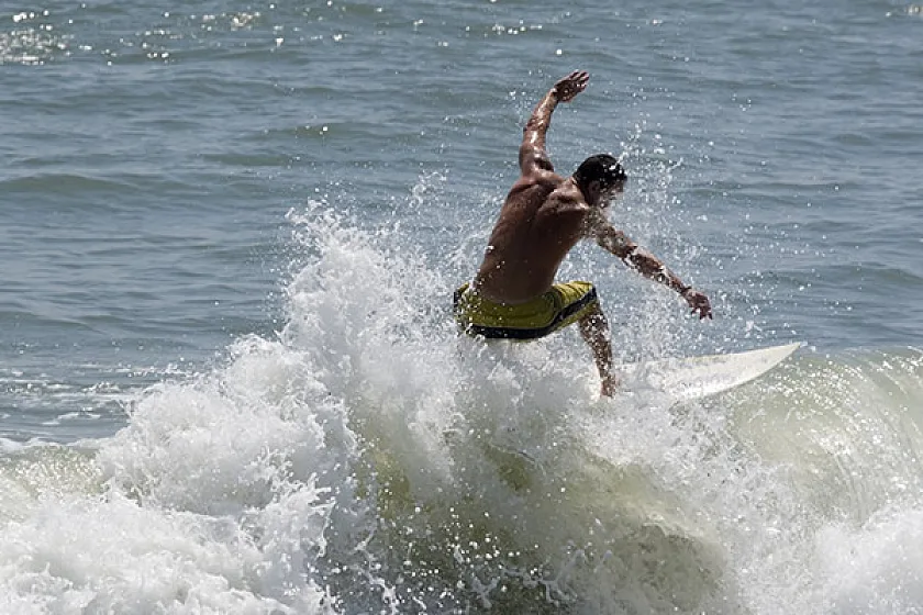 A surfer riding a wave on the Space Coast at Cocoa Beach