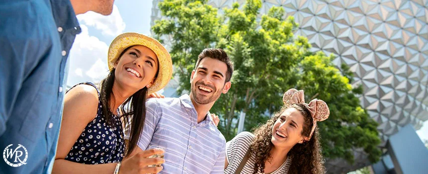 Three friends smiling in front of Spaceship Earth at Epcot