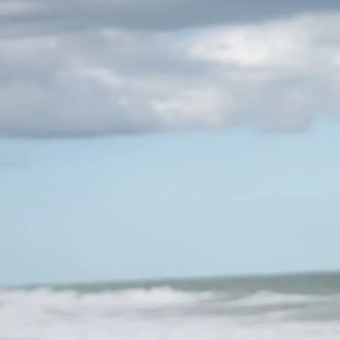 MyrtleBeach.com on Instagram: gray clouds over a pale blue sky and breaking ocean waves