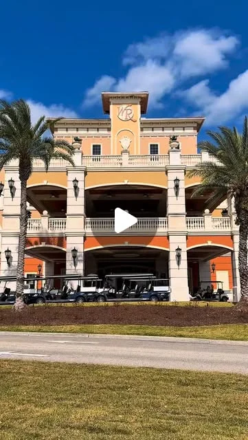 Westgate Resorts on Instagram: peach resort building with a clock tower, arches and palm trees
