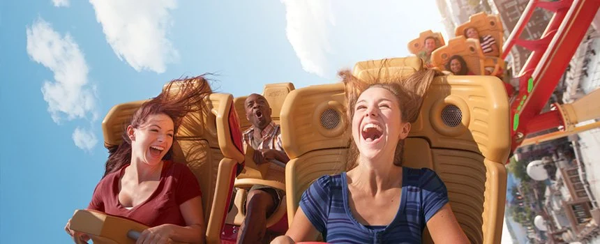 Two women laughing on a roller coaster at Universal Studios Florida