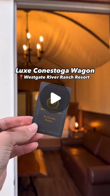 Westgate River Ranch on Instagram: "Luxe Conestoga Wagon" interior with a chandelier and leather sofa