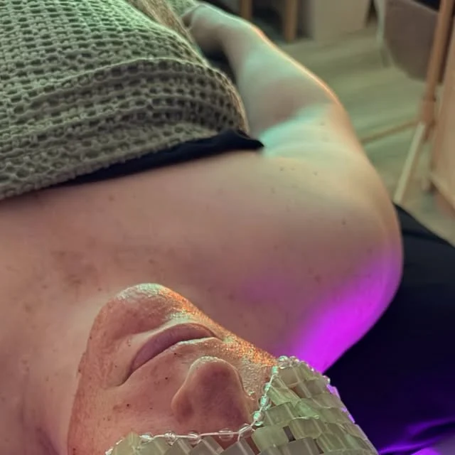 Gina Bay Thompson on Instagram: person lying on a spa bed with eyes covered under a purple glow
