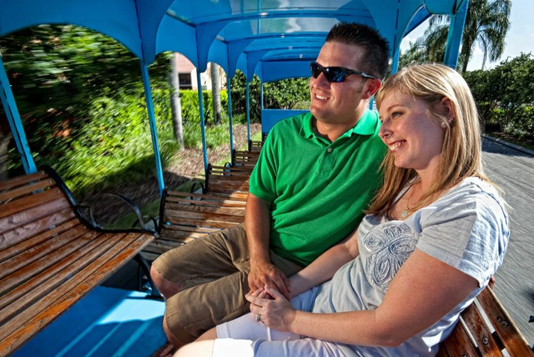Two couples relaxing on a shaded boardwalk bench at a Westgate resort