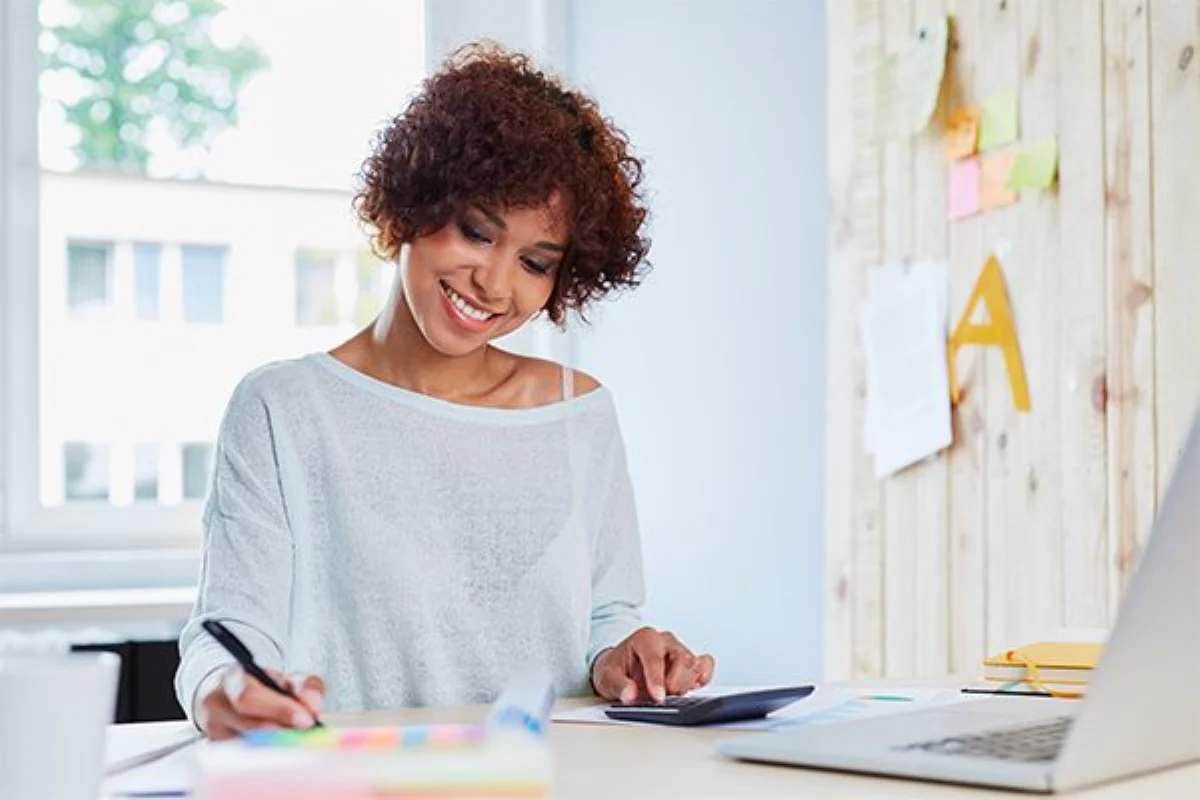 Woman completing a resort preview qualification form at a desk