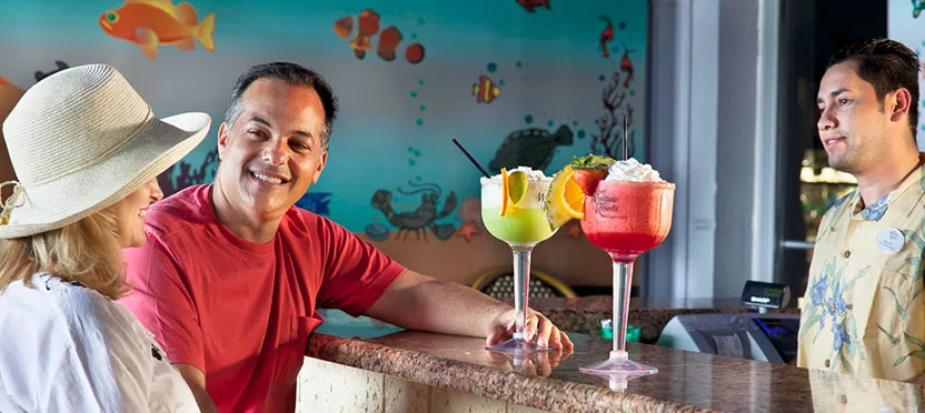 Couple enjoying frozen cocktails at the poolside bar of a Westgate timeshare resort